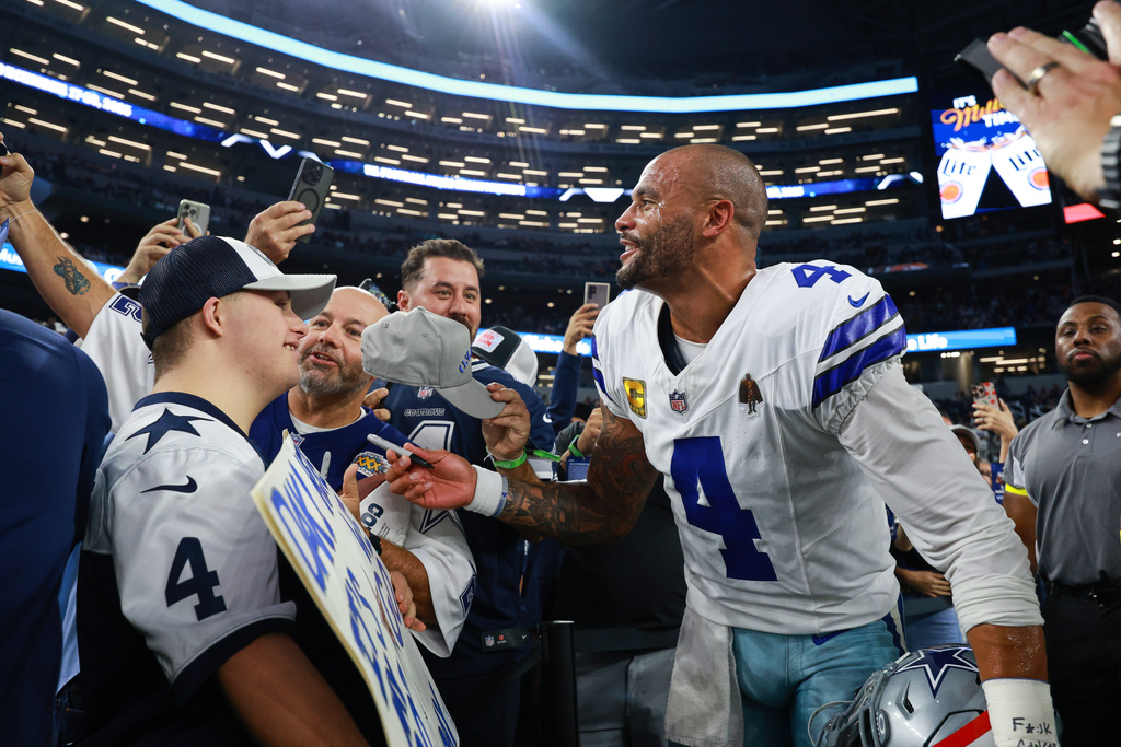 Dallas Cowboys' Dak Prescott talks with fans on the sideline before an NFL football game against the Arizona Cardinals Monday, Nov. 3, 2025, in Arlington, Texas. (AP Photo/Richard Rodriguez)