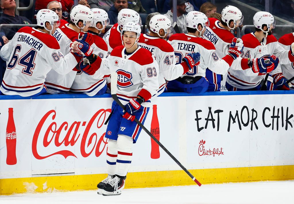 Montréal Canadiens right wing Ivan Demidov (93) is congratulated by teammates after scoring a goal against the New York Islanders during the second period of an NHL hockey game, Sunday, April 12, 2026, in Elmont, N.Y. (AP Photo/Noah K. Murray