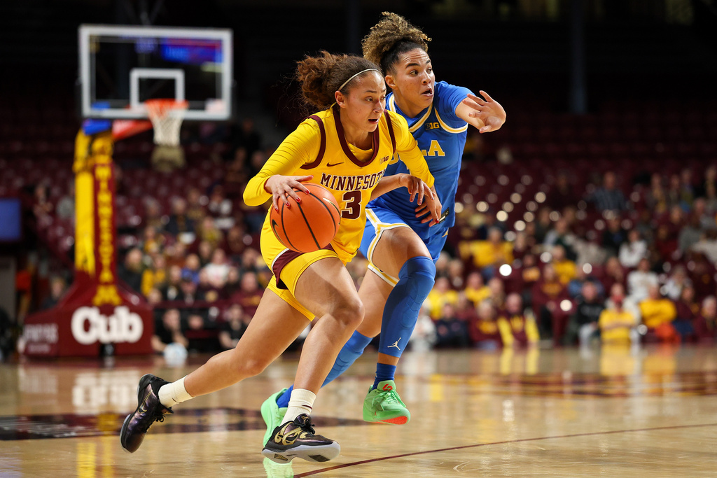 Minnesota Golden Gophers guard Amaya Battle, left, works around UCLA Bruins guard Kiki Rice (1) during the second half of an NCAA college basketball game, Wednesday, Jan. 14, 2026, in Minneapolis. (AP Photo/Matt Krohn)