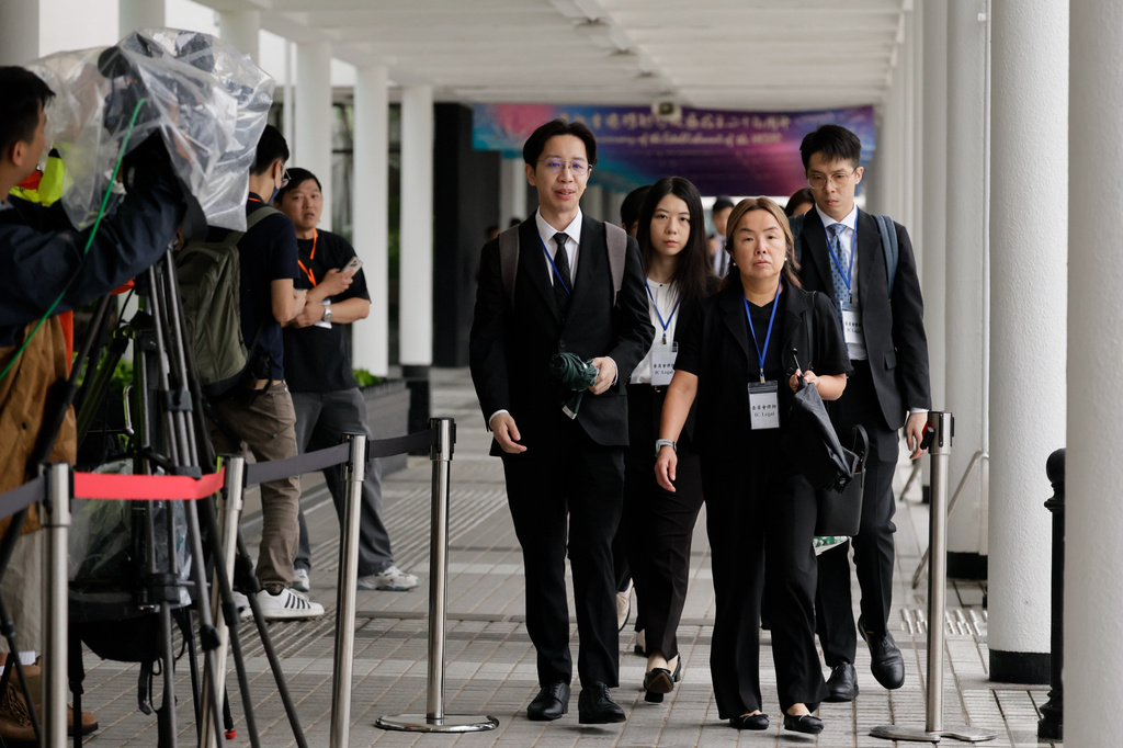 Members of Independant Commission team arrives for the closing submissions at the Independent Commission investigation hearing into last year's Tai Po deadly fire, in Hong Kong, Friday, July 17, 2026. (AP Photo/May James)