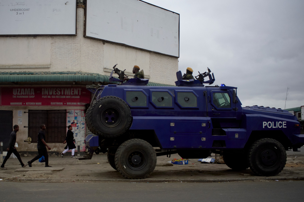 A police vehicle is parked on a sidewalk, on the outskirts of Lusaka, Zambia, Friday, Aug. 14, 2026. (AP Photo/Alfonso Nqunjana)