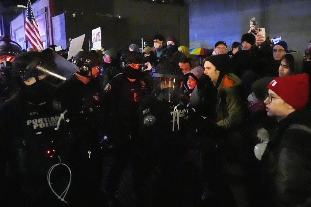 Protesters stand off against law enforcement outside the U.S. Immigration and Customs Enforcement facility in Portland, Ore., Thursday, Jan. 8, 2026. (AP Photo/Jenny Kane)