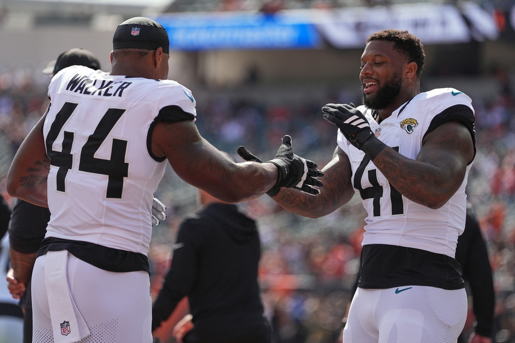 Jacksonville Jaguars defensive end Travon Walker (44) and Jacksonville Jaguars defensive end Josh Hines-Allen (41) before an NFL football game in Cincinnati, Sunday, Oct. 4, 2026. (AP Photo/Joshua A. Bickel)