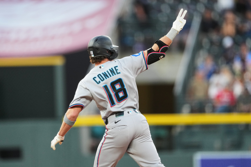Miami Marlins pinch hitter Griffin Conine gestures to the bullpen as he circles the bases after hitting a three-run home run off Colorado Rockies relief pitcher Victor Vodnik in the fifth inning of a baseball game Monday, June 29, 2026, in Denver. (AP Photo/David Zalubowski)