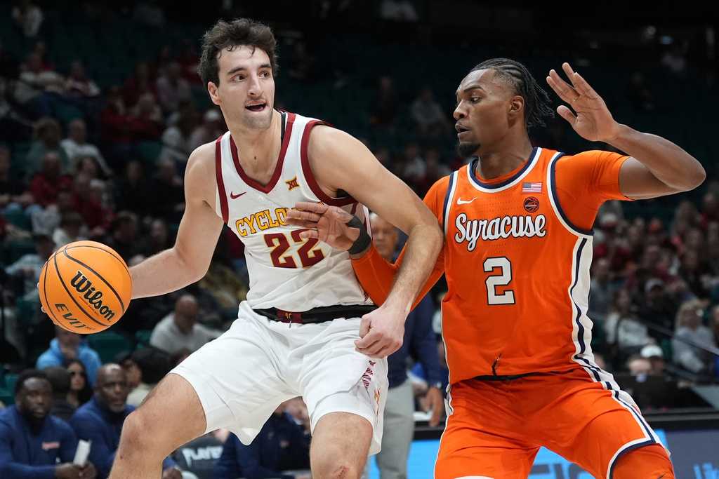 Iowa State forward Milan Momcilovic (22) drives around Syracuse guard JJ Starling (2) during the first half of an NCAA college basketball game in the Players Era tournament in Las Vegas, Wednesday, Nov. 26, 2025. (AP Photo/Eric Gay)