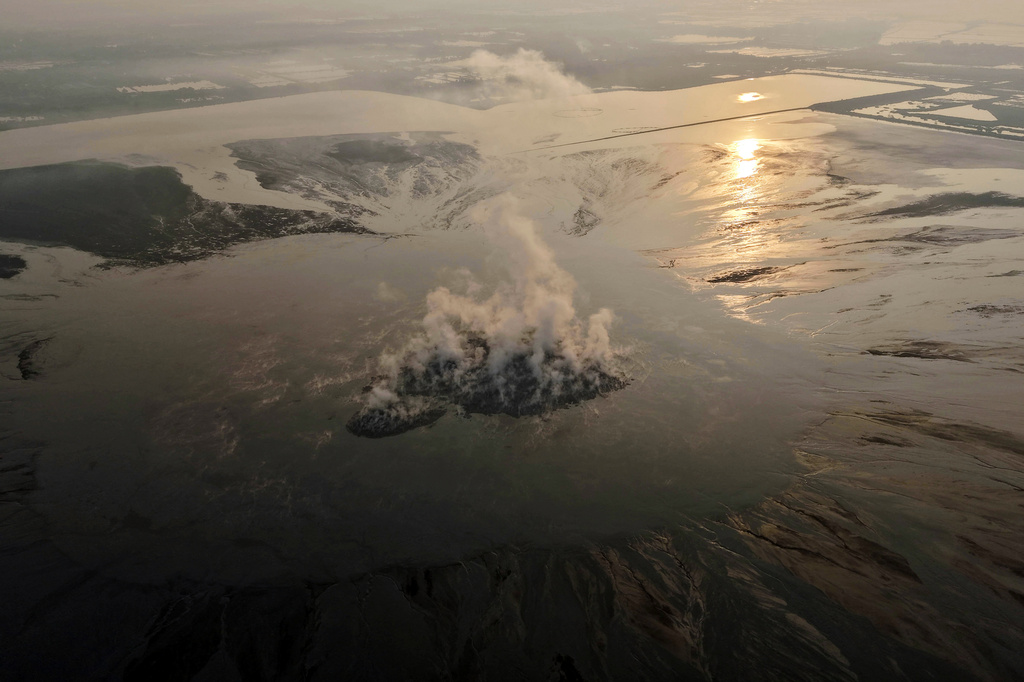 Smoke billows from the crater of the "mud volcano" that was caused by a gas exploration accident in 2006, in Sidoarjo, East Java, Indonesia, Friday, May 29, 2026. (AP Photo/Trisnadi)