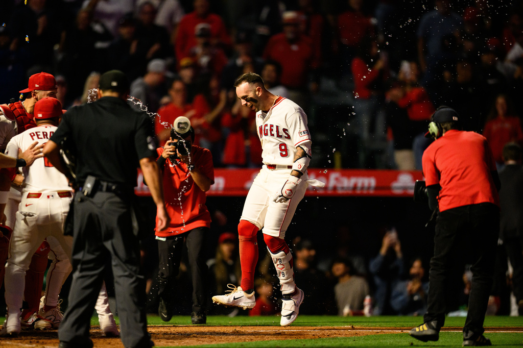 Los Angeles Angels' Zach Neto (9) is greeted by teammates after hitting a walk0ff home run during the ninth inning of a baseball game against the Athletics, Monday, May 18, 2026, in Anaheim, Calif. (AP Photo/William Liang)