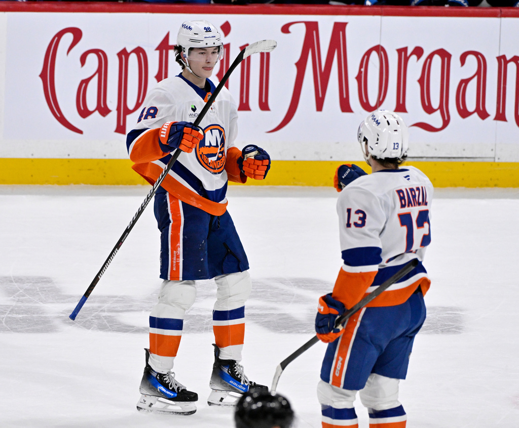New York Islanders' Matthew Schaefer (48) celebrates his goal against the Winnipeg Jets with Mathew Barzal (13) during the third period of an NHL hockey game in Winnipeg, Manitoba, Tuesday, Jan. 13, 2026. (Fred Greenslade/The Canadian Press via AP)