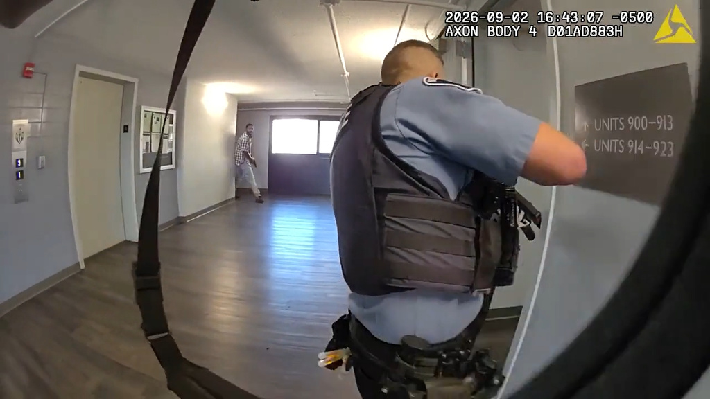 This image made from body camera video provided by the Minneapolis Police Department of a Wednesday, Sept. 2, 2026, shooting shows Minneapolis police Officer Joseph Michnowski looking down an apartment hallway as Carlton Johnson emerges with a handgun. (City of Minneapolis via AP)