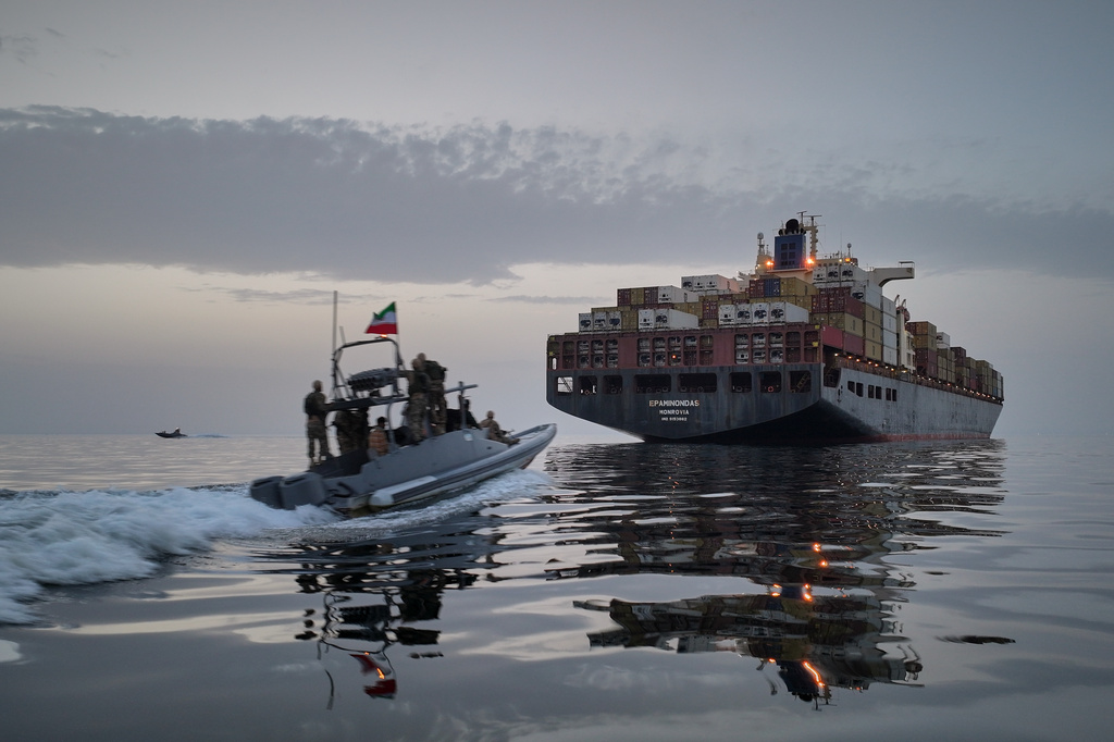 FILE - In this photo released by Tasnim News Agency, a Revolutionary Guard Navy (IRGC) speedboat approaches the cargo ship Epaminondas during what state media described as the seizure of one of two vessels accused of violations in the Strait of Hormuz, April 21, 2026. (Meysam Mirzadeh/Tasnim News Agency via AP, File)