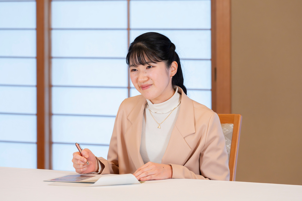 In this photo provided by the Imperial Household Agency of Japan, Princess Aiko, the daughter of Japan's Emperor Naruhito and Empress Masako, poses for a photo at the Imperial Palace in Tokyo, Monday, Nov. 10, 2025. (Imperial Household Agency of Japan via AP)