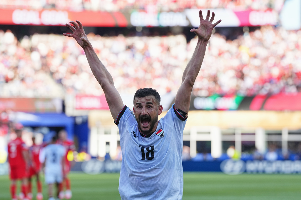 Iraq's Aymen Hussein celebrates scoring his side's first goal during the World Cup Group I soccer match between Iraq and Norway in Foxborough, Mass., near Boston, Tuesday, June 16, 2026. (AP Photo/Martin Meissner)