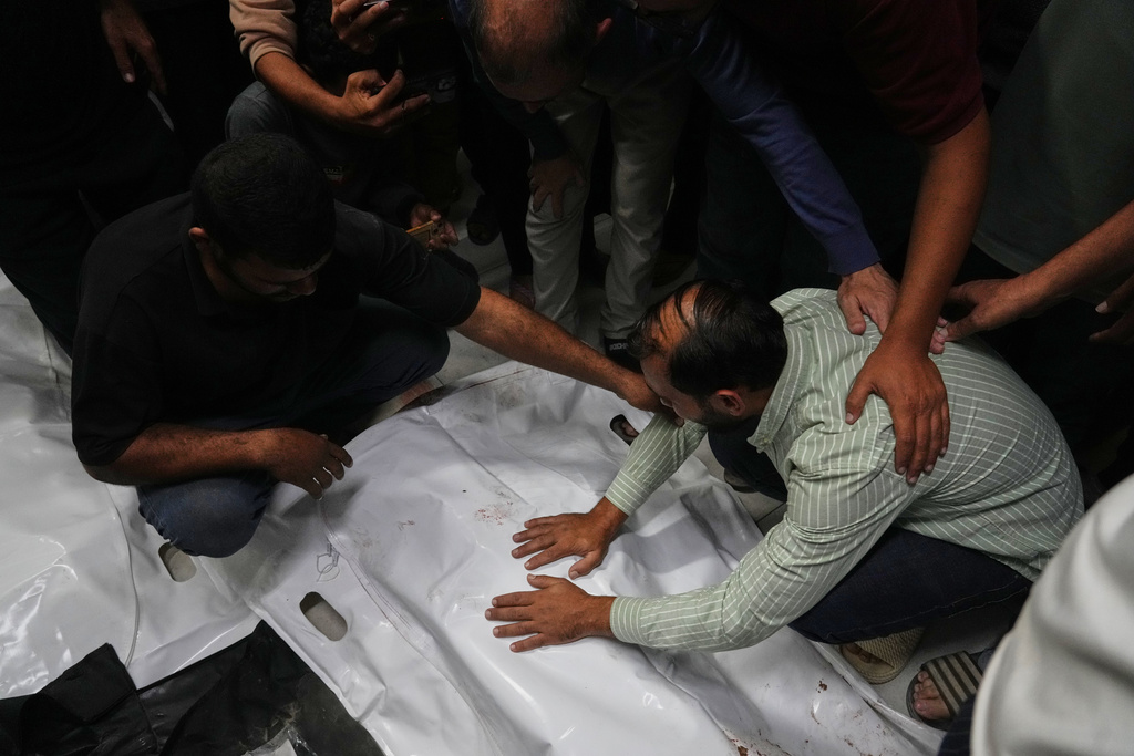 The bodies of Palestinians killed in an Israeli army strike are brought to Nasser Hospital in Khan Younis, Gaza Strip, Tuesday, Oct. 28, 2025. (AP Photo/Jehad Alshrafi)