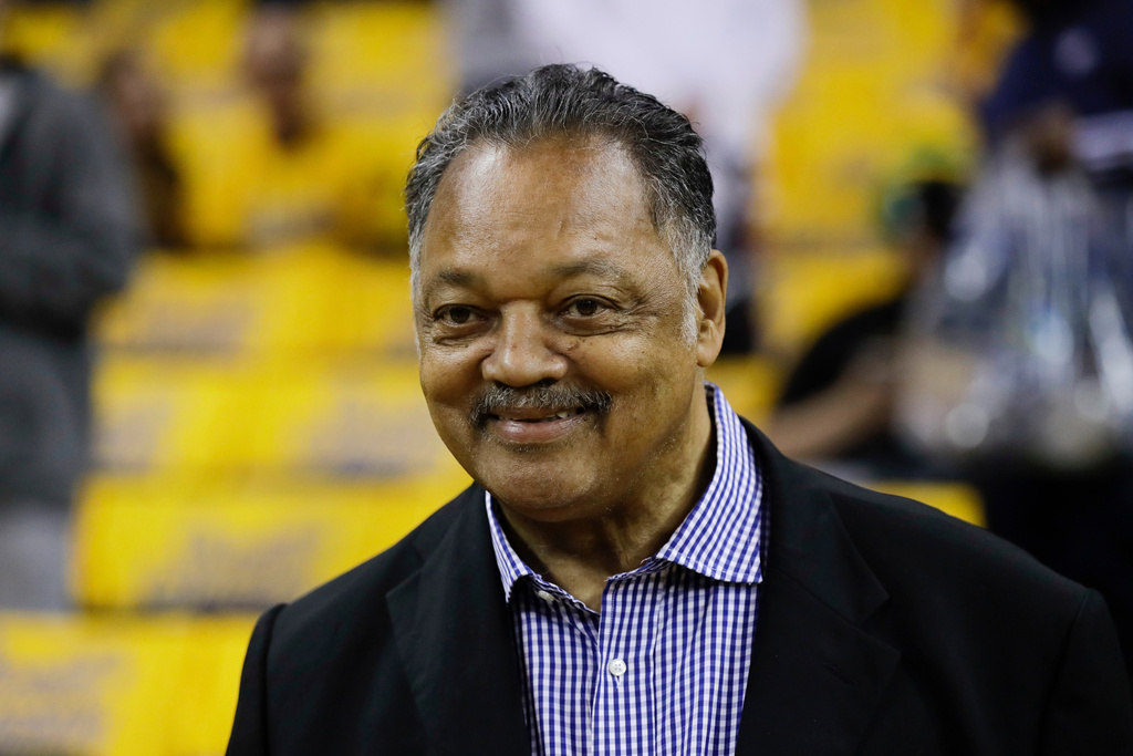 FILE - The Rev. Jesse Jackson watches as players warm up before Game 1 of basketball's NBA Finals between the Golden State Warriors and the Cleveland Cavaliers in Oakland, Calif., Thursday, May 31, 2018. (AP Photo/Marcio Jose Sanchez, File)