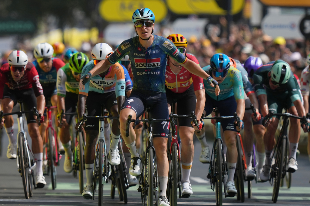 Belgium's Tim Merlier celebrates as he crosses the finish line to win the seventh stage of the Tour de France cycling race with start in Hagetmau and finish in Bordeaux, France, Friday, July 10, 2026. (AP Photo/Thibault Camus)