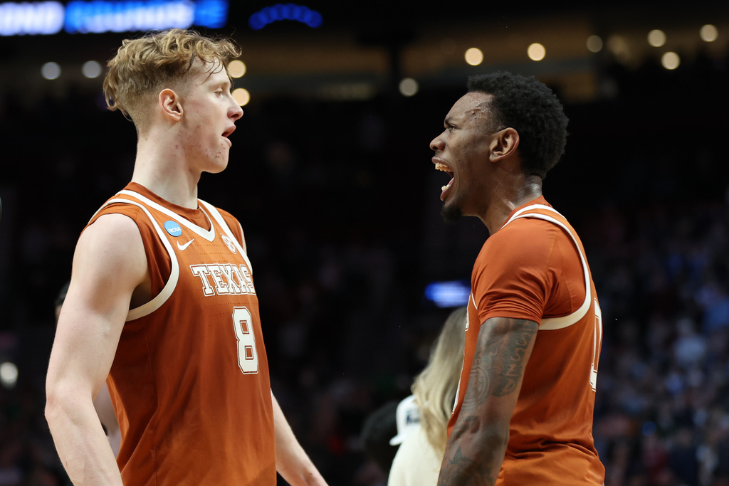 Texas center Matas Vokietaitis (8) celebrates with forward Nic Codie after the second round of the NCAA college basketball tournament against the Gonzaga, Saturday, March 21, 2026, in Portland, Ore.(AP Photo/Amanda Loman)