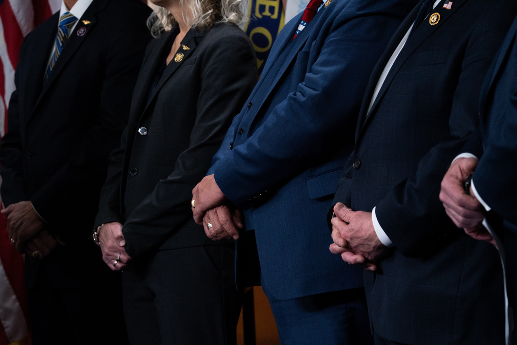 Members of the House GOP cross their hands at a news conference calling for the reopening of the Department of Homeland Security during the partial shutdown, Thursday, March 5, 2026, in Washington. (AP Photo/Allison Robbert)