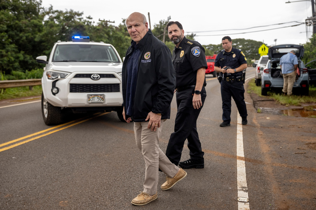 Honolulu Mayor Rick Blangiardi surveys flood damages in Haleiwa, Hawaii Saturday, March 21, 2026. (Stephen Lam/San Francisco Chronicle via AP)