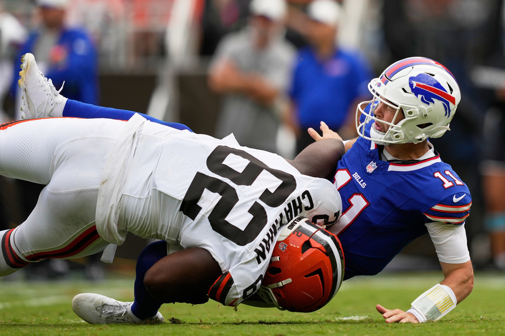 Buffalo Bills quarterback Kyle Allen (11) is tackled by Cleveland Browns defensive tackle Elijah Chatman (62) after passing during the first half of an NFL preseason football game, Saturday, Aug. 22, 2026, in Cleveland. (AP Photo/Carolyn Kaster)