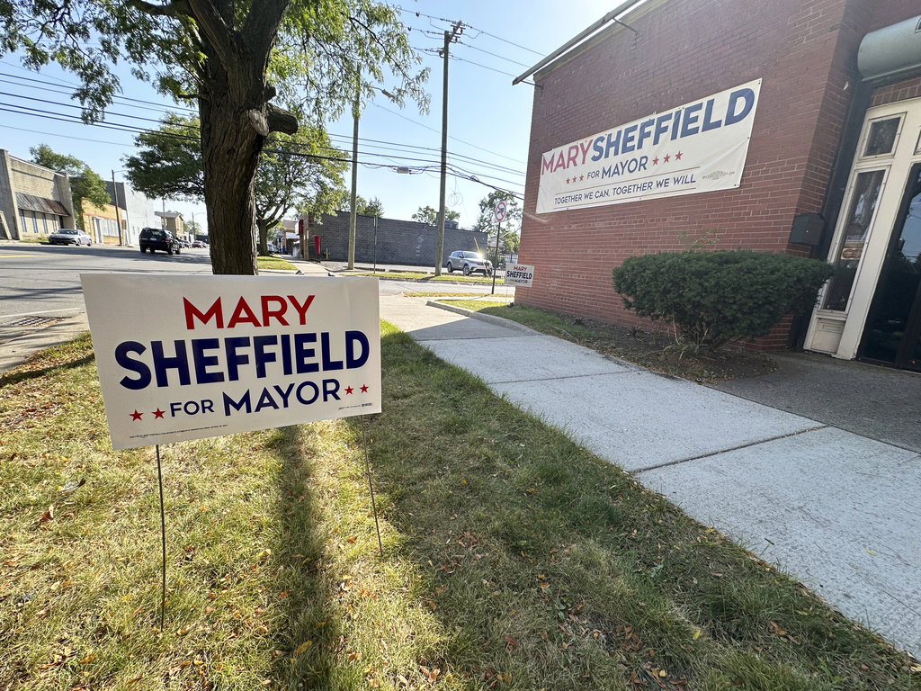 A lawn sign and banner are pictured on display outside a campaign office for Detroit mayoral candidate Mary Sheffield, Saturday, Sept. 27, 2025, on Detroit's west side. (AP Photo/Robert Yoon)