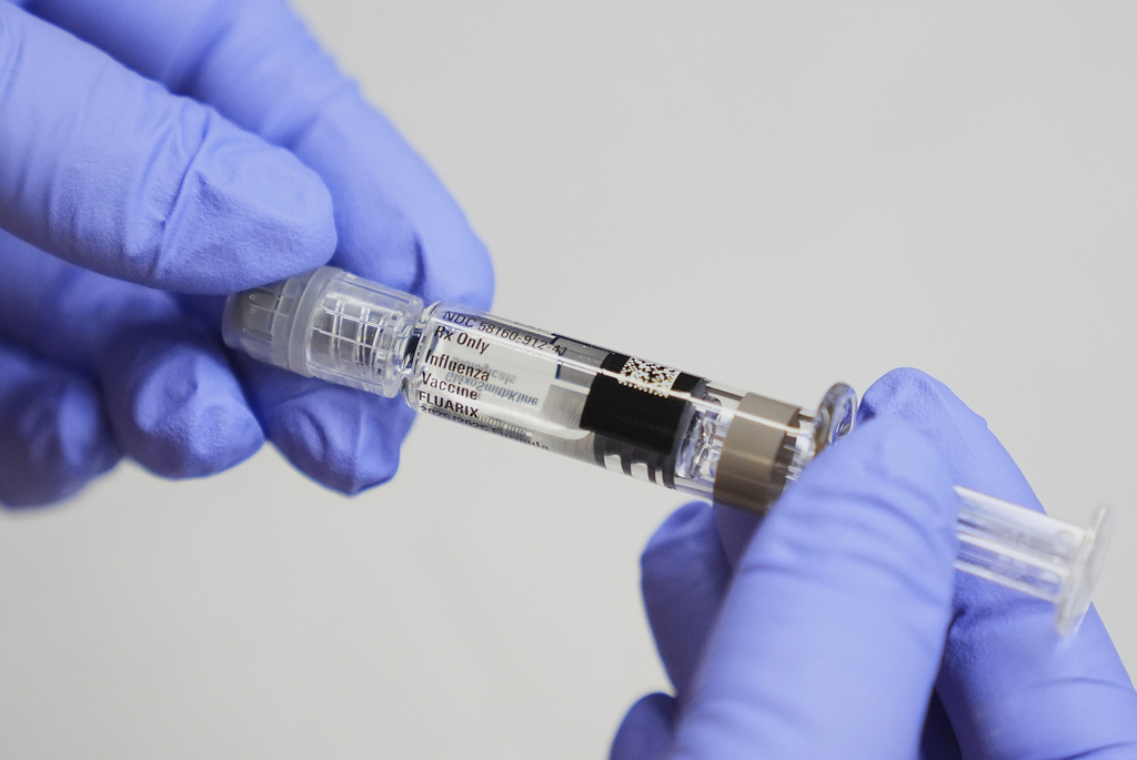 Clinic support supervisor May Fengmei Lin, CMA, displays a syringe of the Fluarix flu vaccine at International Community Health Services, Wednesday, Sept. 10, 2025, in Seattle. (AP Photo/Lindsey Wasson)