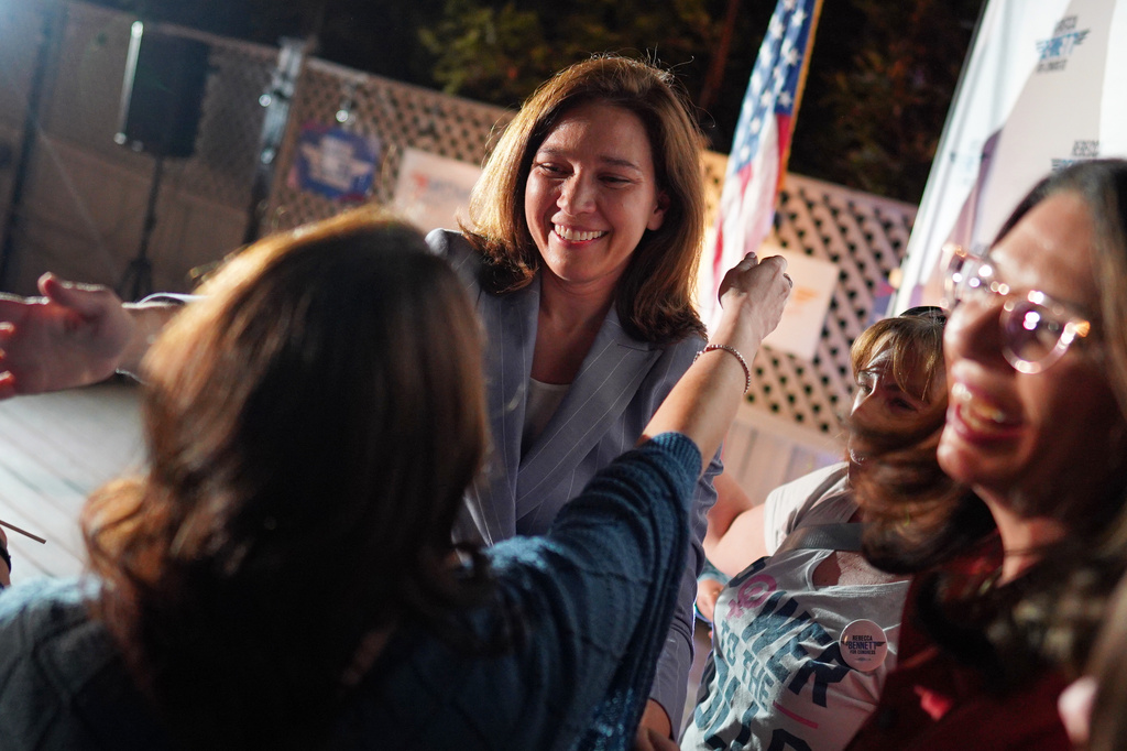 Rebecca Bennett, Democratic candidate for New Jersey's 7th Congressional District, hugs attendees during a primary election night watch party after winning the Democratic nomination Tuesday, June 2, 2026, in Bridgewater, N.J. (AP Photo/Ryan Murphy)