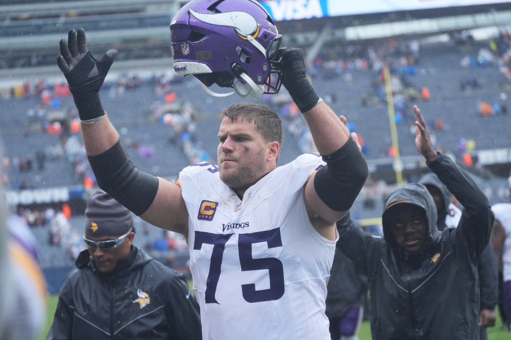 Minnesota Vikings offensive tackle Brian O'Neill (75) celebrates as he walks off the field after the Vikings defeated the Chicago Bears in an NFL football game in Chicago, Sunday, Sept. 20, 2026. (AP Photo/David Banks)