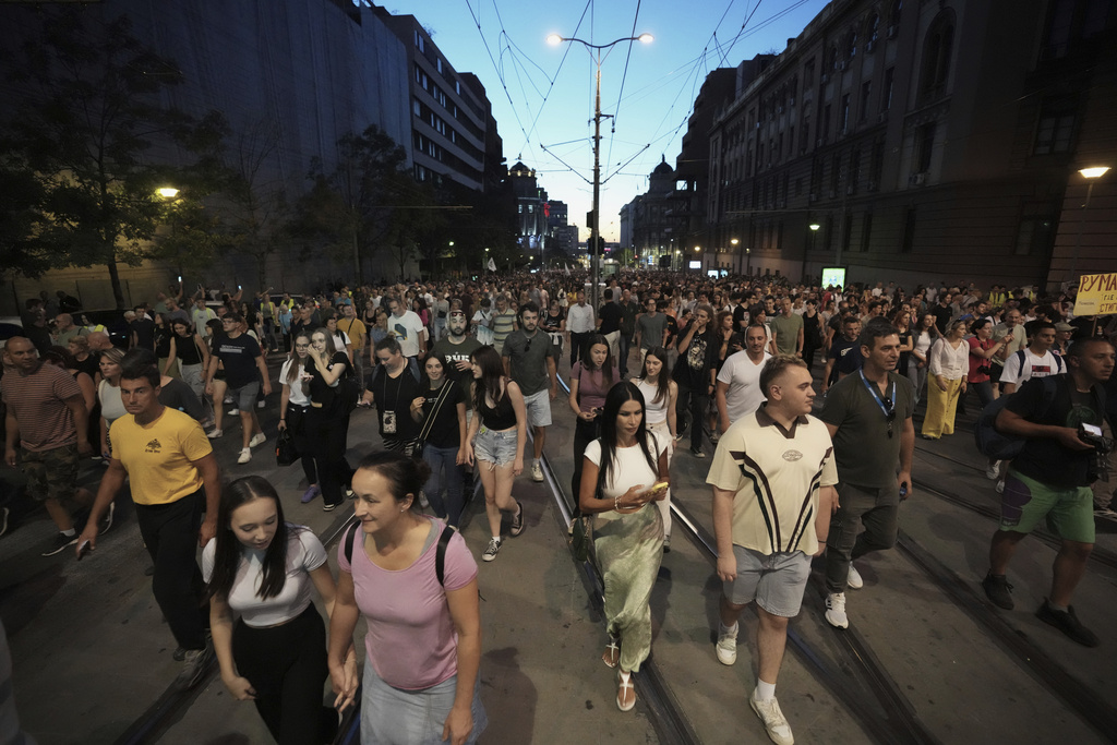 People march during an anti-government rally pressing for an early election after ten months of almost daily anti-corruption demonstrations that have shaken the populist government of President Aleksandar Vucic, in Belgrade, Serbia, Monday, Sept. 1, 2025. (AP Photo/Darko Vojinovic)