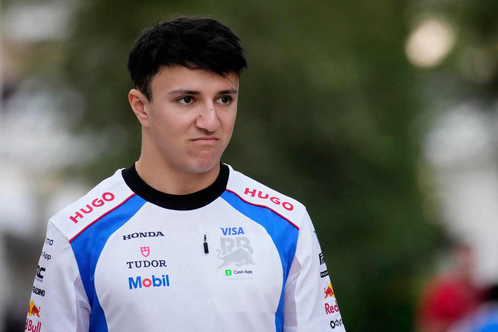 Racing Bulls driver Isack Hadjar of France walks through the paddock at the Lusail International Circuit ahead of the Qatar Formula One Grand Prix, in Lusail, Qatar, Thursday, Nov. 27, 2025. (AP Photo/Darko Bandic)