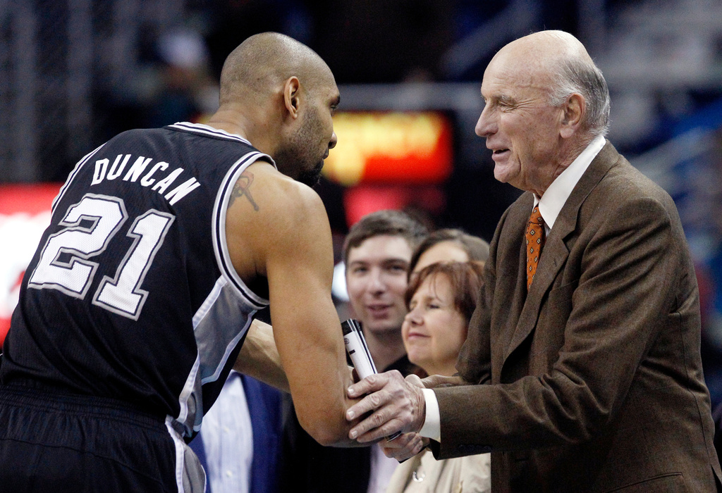 FILE - San Antonio Spurs power forward Tim Duncan (21) shakes hands with former NBA player Bob Pettit before the start of the Spurs New Orleans Hornets NBA basketball game in New Orleans, Monday, Jan. 7, 2013. (AP Photo/Bill Haber, File)