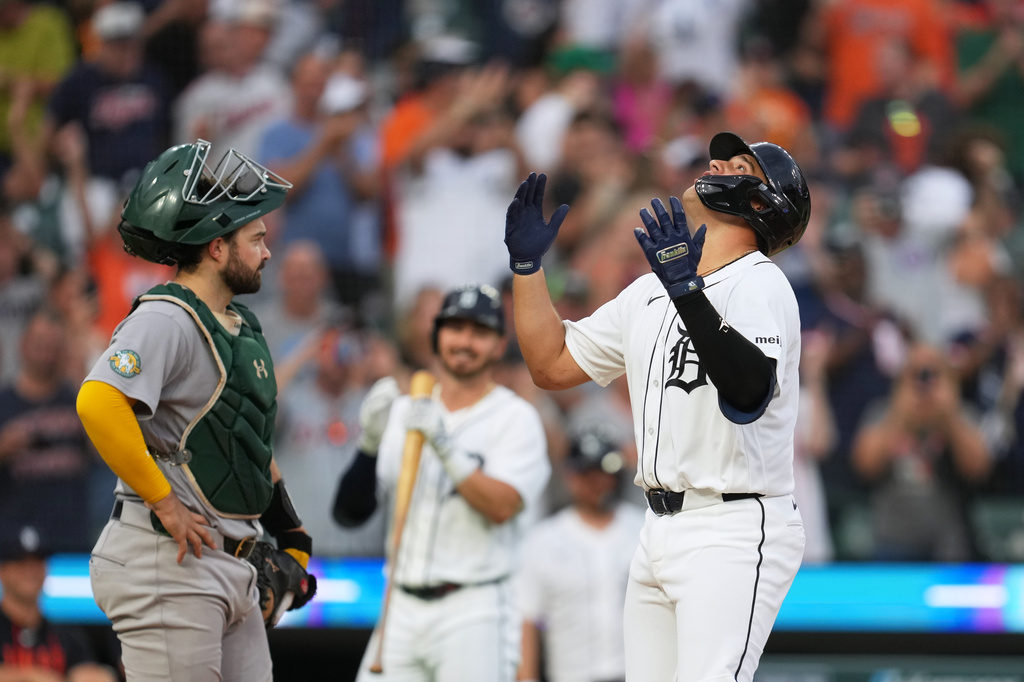 Detroit Tigers' Eduardo Valencia, right, reacts to hitting a home run as Athletics catcher Shea Langeliers, left, looks on during the seventh inning of a baseball game Thursday, July 9, 2026, in Detroit. (AP Photo/Paul Sancya)