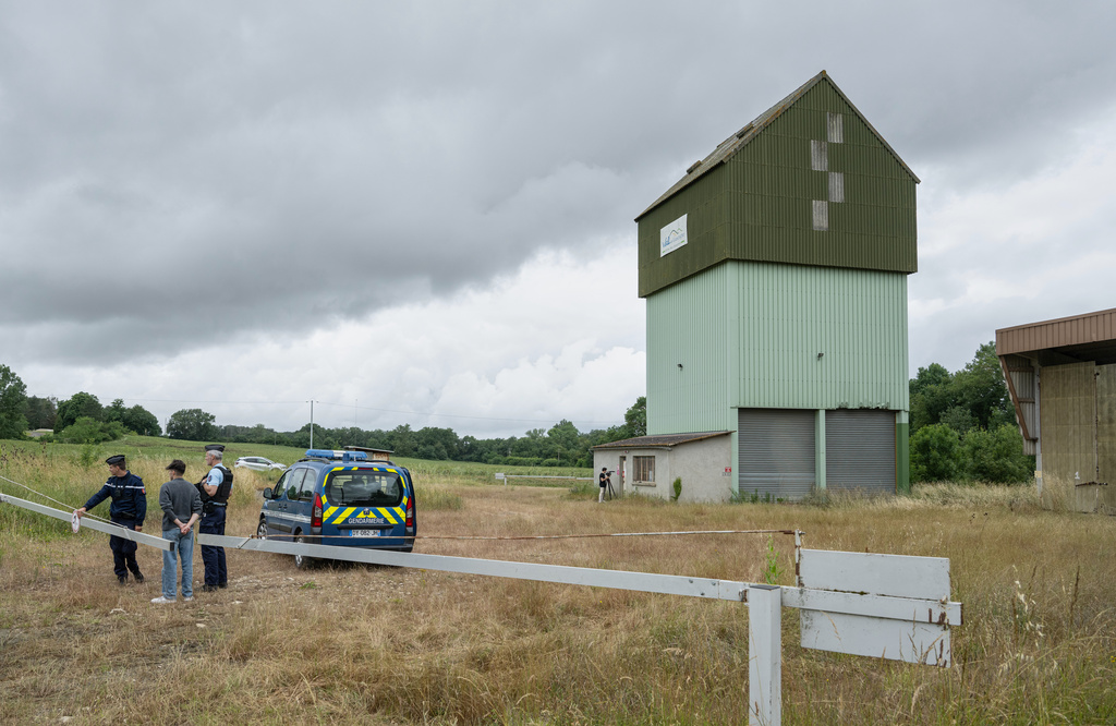 French police guard a farm silo where a body was found yesterday during the search to find missing 11 year-old girl Lyhanna in Puycasquier, southwestern France, Friday, June,5, 2026. (AP Photo/Frederic Lancelot)