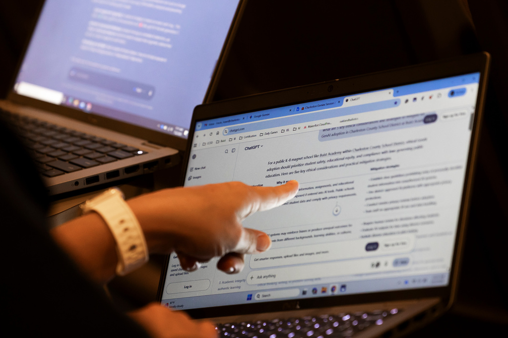 Teachers work with AI on their laptops during the Charleston County School District Charleston Educator Symposium Wednesday, July 22, 2026, in North Charleston, S.C. (AP Photo/Mic Smith)