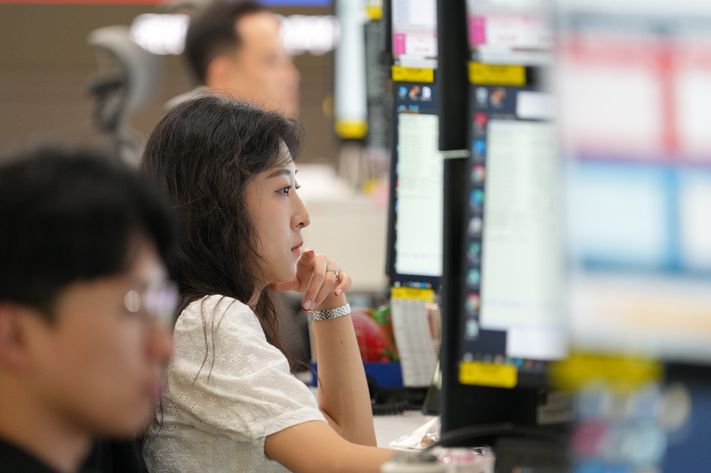 Dealers work at a dealing room of Hana Bank in Seoul, South Korea, Thursday, June 18, 2026. (AP Photo/Lee Jin-man)