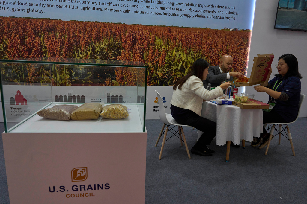 FILE - Workers eat lunch at the U.S. Grains booth during the China International Supply Chain Expo in Beijing, Wednesday, Nov. 27, 2024. (AP Photo/Ng Han Guan, File)