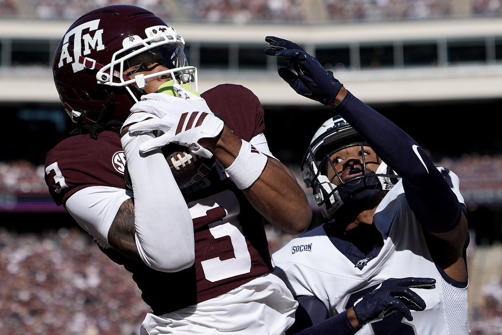 Texas A&M wide receiver Ashton Bethel-Roman (3) catches a pass for a thouchdown over over Samford cornerback Nahil Perkins (3) during the first quarter of an NCAA college football game Saturday, Nov. 22, 2025, in College Station, Texas. (AP Photo/Sam Craft)