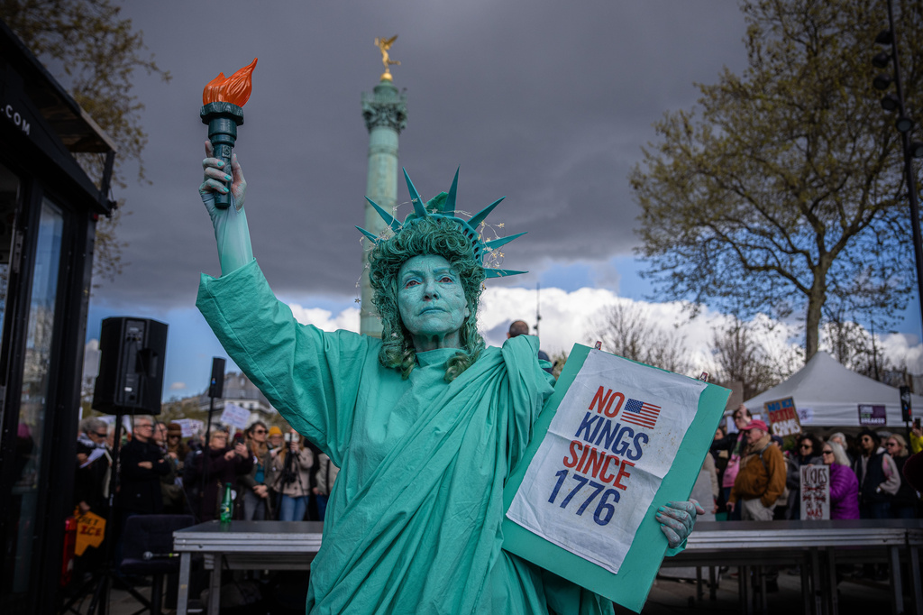 A woman dressed as the Statue of Liberty takes part in the "No Kings" protest in Paris, France, Saturday, March 28, 2026. (AP Photo/Aurelien Morissard)