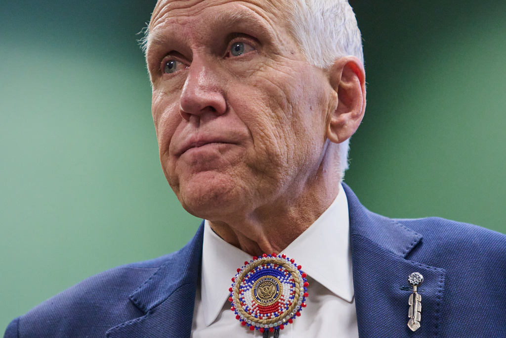 FILE - Wearing a beaded bolo around a pin that says "United States Senate," Sen. Thom Tillis, R-N.C., listens to thanks from members of the Lumbee Tribe of North Carolina, after the passage of a bill granting the tribe with federal recognition, on Capitol Hill, in Washington, Dec. 17, 2025. (AP Photo/Jacquelyn Martin, File)