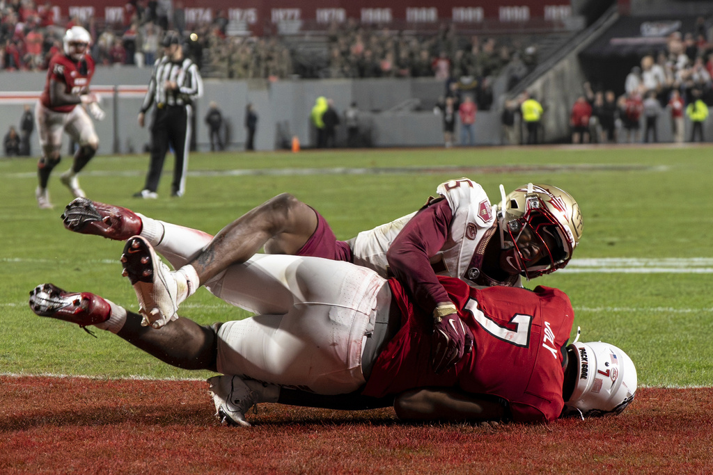Florida State wide receiver Lawayne McCoy (7) is tackled in the end zone by Florida State defensive back Shamar Arnoux (15) during the second half of an NCAA college football game, Friday, Nov. 21, 2025, in Raleigh, N.C. (AP Photo/David Yeazell)