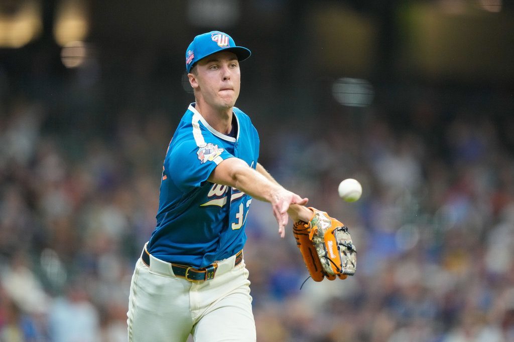 Milwaukee Brewers pitcher Jacob Misiorowski tosses out Atlanta Braves' Drake Baldwin at first base during the third inning of a baseball game Friday, Aug. 21, 2026, in Milwaukee. (AP Photo/Kayla Wolf)