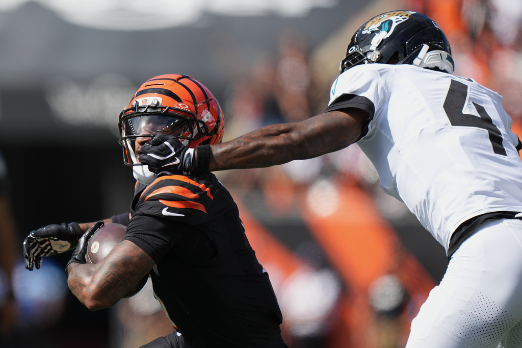 Jacksonville Jaguars cornerback Jarrian Jones (4) gets a face mask penalty against Cincinnati Bengals wide receiver Ja'marr Chase (1) during an NFL football game in Cincinnati, Sunday, Oct. 4, 2026. (AP Photo/Joshua A. Bickel)