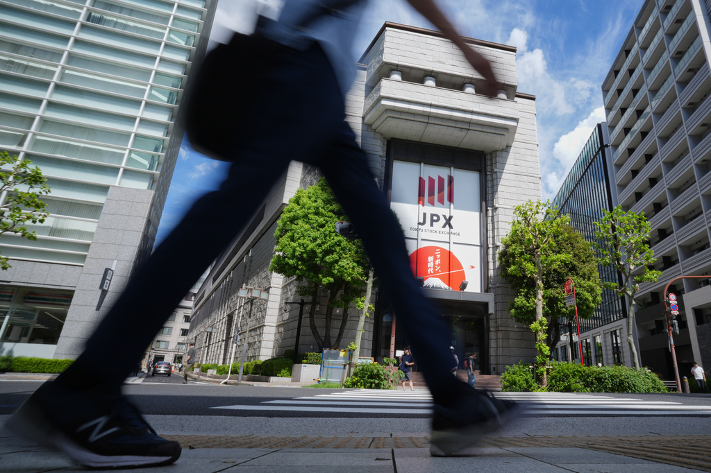 A person walk in front of Tokyo Stock Exchange Tuesday, Aug. 18, 2026, in Tokyo. (AP Photo/Eugene Hoshiko)