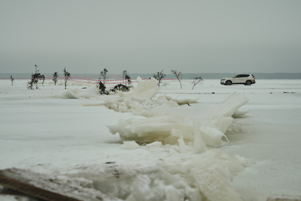 A car drives on the frozen Soela Strait in the Baltic Sea near Hiiumaa, Estonia, Tuesday, Feb. 10, 2026. (AP Photo/Kostya Manekov)