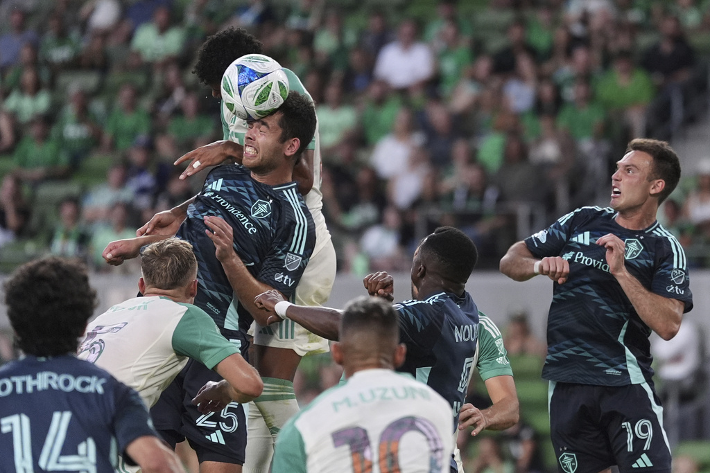 Seattle Sounders' Jackson Ragen (25) heads the ball to block a pass in front of Austin FC's Owen Wolff, back center, during the second half of an MLS soccer match in Austin, Texas, Sunday, Sept. 21, 2025. (AP Photo/Eric Gay)