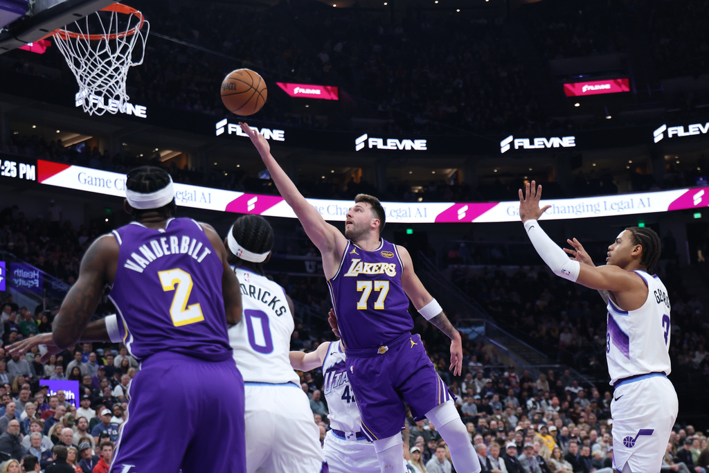 Los Angeles Lakers guard Luka Doncic (77) lays up the ball against the Utah Jazz during the first quarter of an NBA basketball game Thursday, Dec. 18, 2025, in Salt Lake City. (AP Photo/Rob Gray)