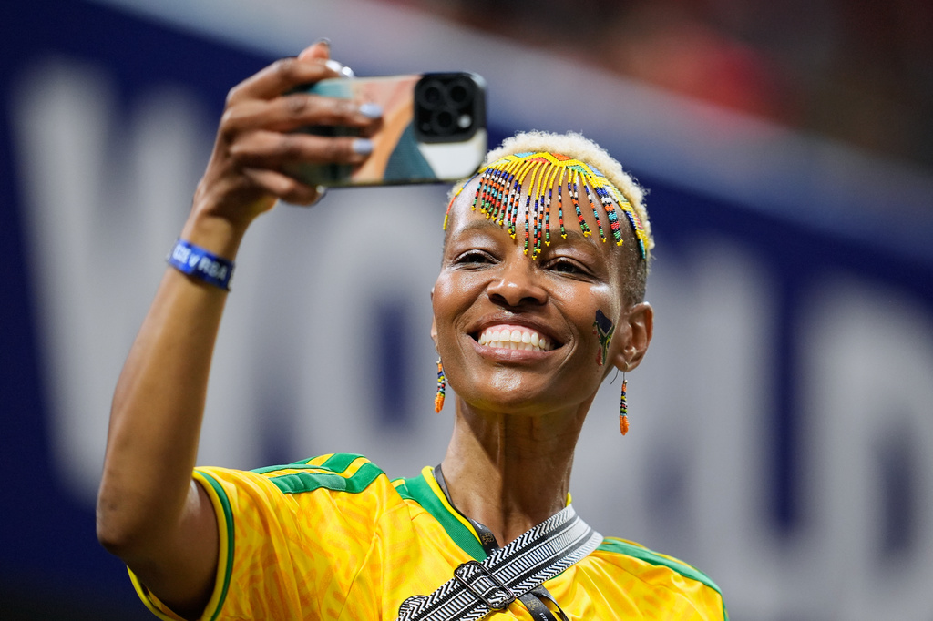 A South Africa fan in the stands shoots pictures before the World Cup Group A soccer match between Czechia and South Africa in Atlanta, Thursday, June 18, 2026. (AP Photo/Mike Stewart)