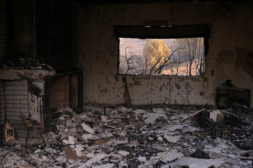 A house destroyed by a wildfire is photographed near Almorox, Toledo province, Spain, Thursday, July 30, 2026. (AP Photo/Manu Fernandez)