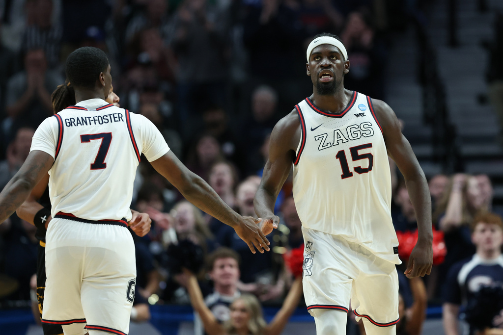 Gonzaga forward Graham Ike (15) reacts with guard Tyon Grant-Foster after a play during the second half in the first round of the NCAA college basketball tournament against Kennesaw State, Thursday, March 19, 2026, in Portland, Ore. (AP Photo/Amanda Loman)