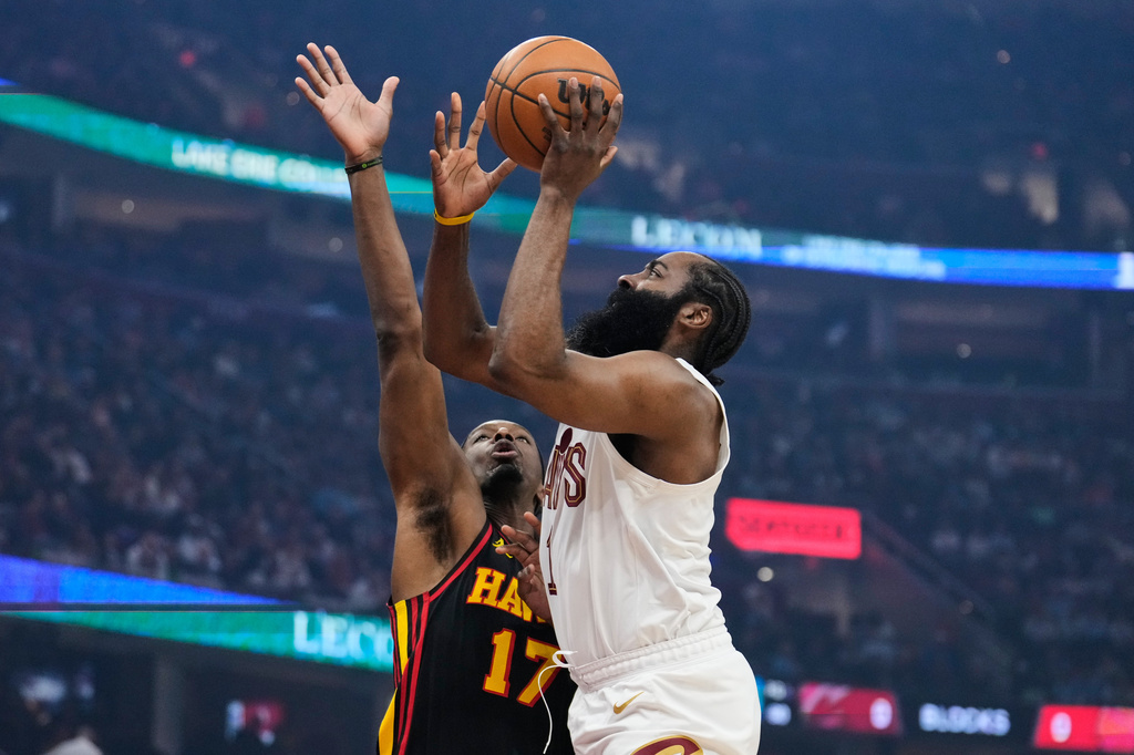 Cleveland Cavaliers guard James Harden, right, shoots as Atlanta Hawks forward Onyeka Okongwu (17) defends in the first half of an NBA basketball game in Cleveland, Wednesday, April 8, 2026. (AP Photo/Sue Ogrocki)