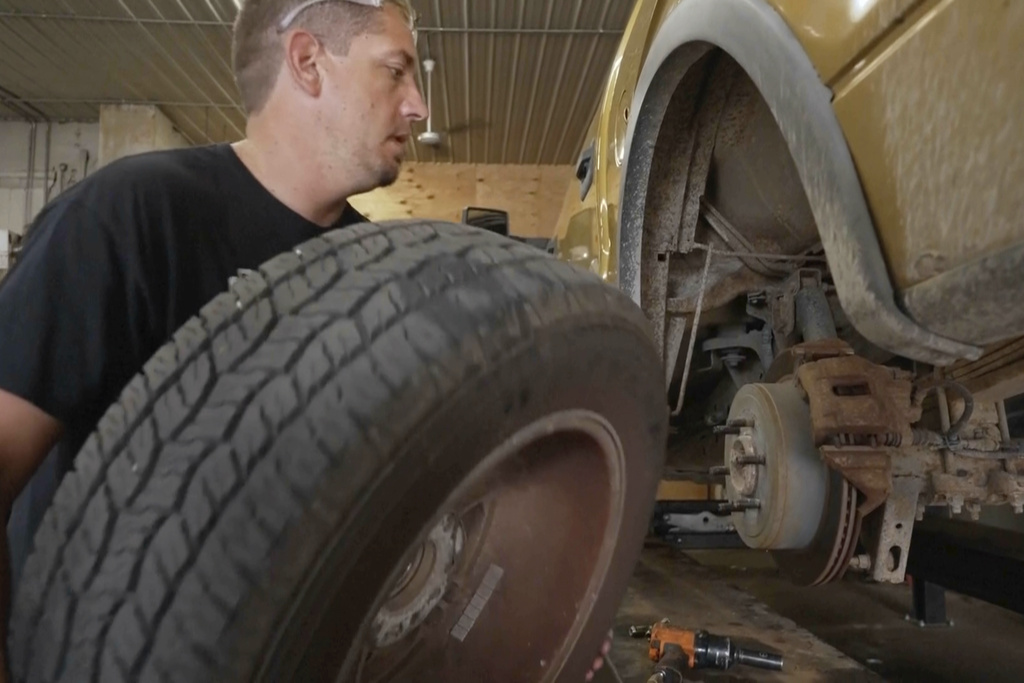 Mechanic Chad Volk works on a vehicle in his shop in Lake Crystal, Minn., on Aug. 14 2025. (AP Photo/Mark Vancleave)